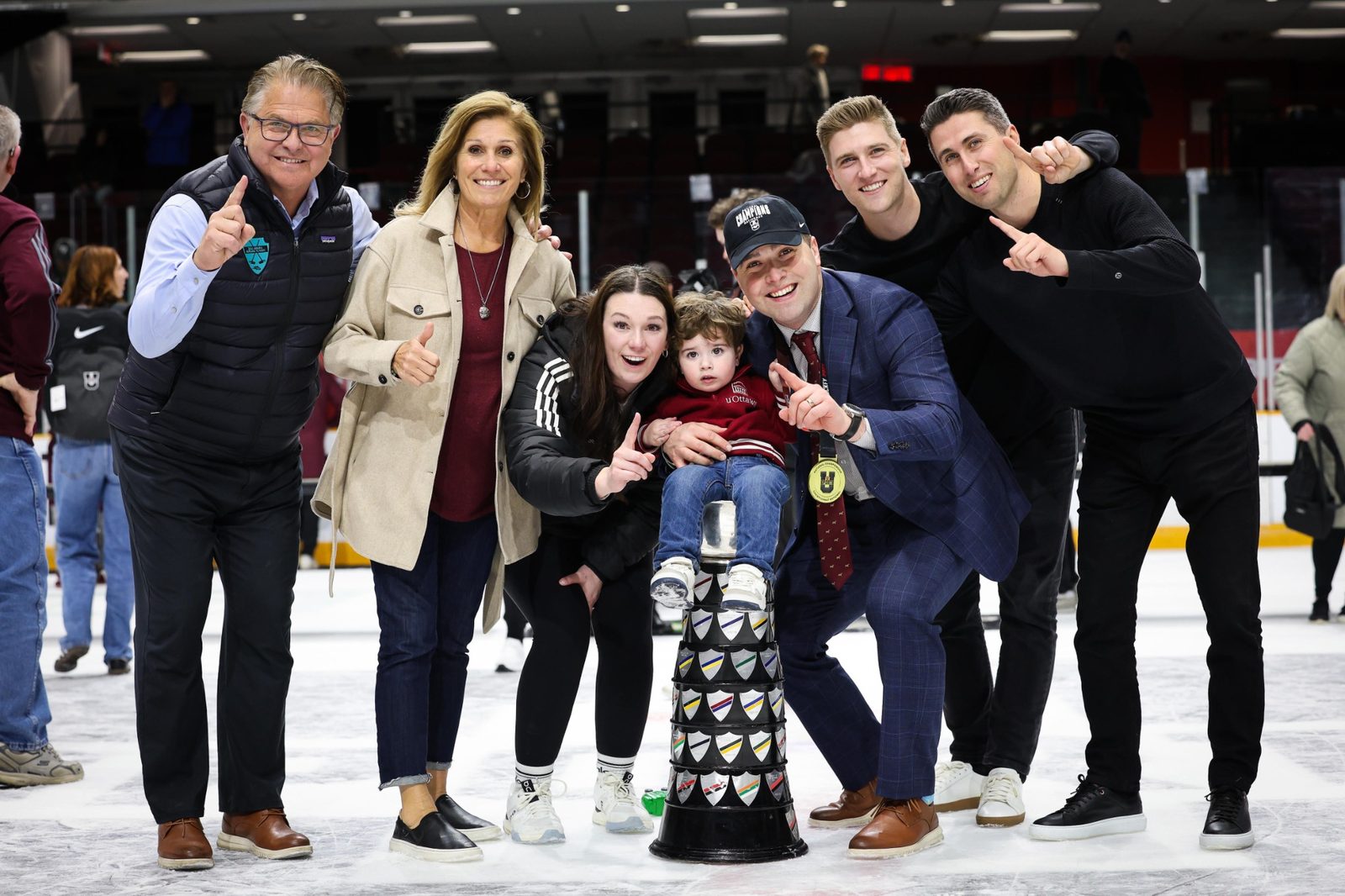 Family celebrating with championship trophy