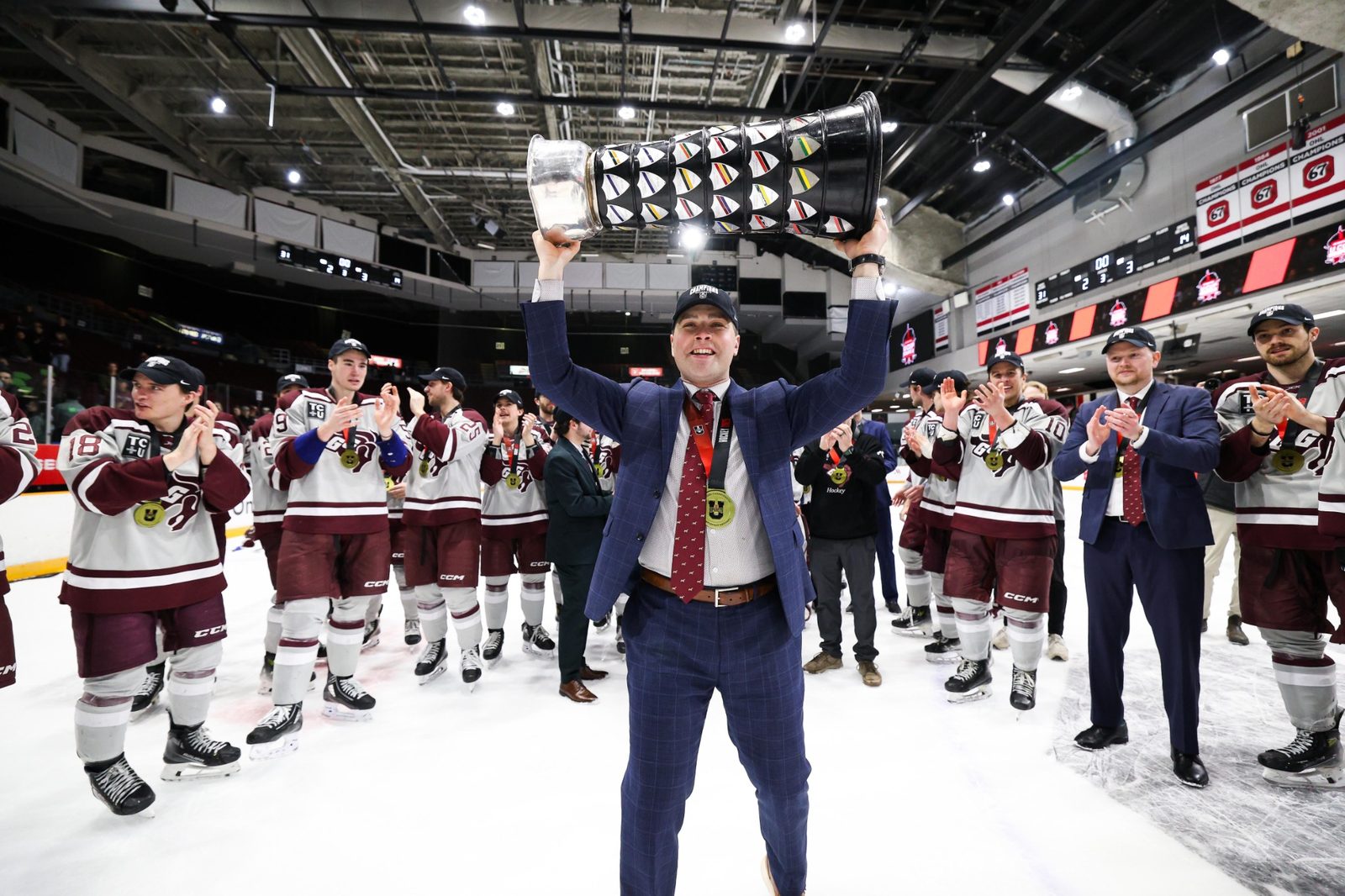 Coaches with championship trophy